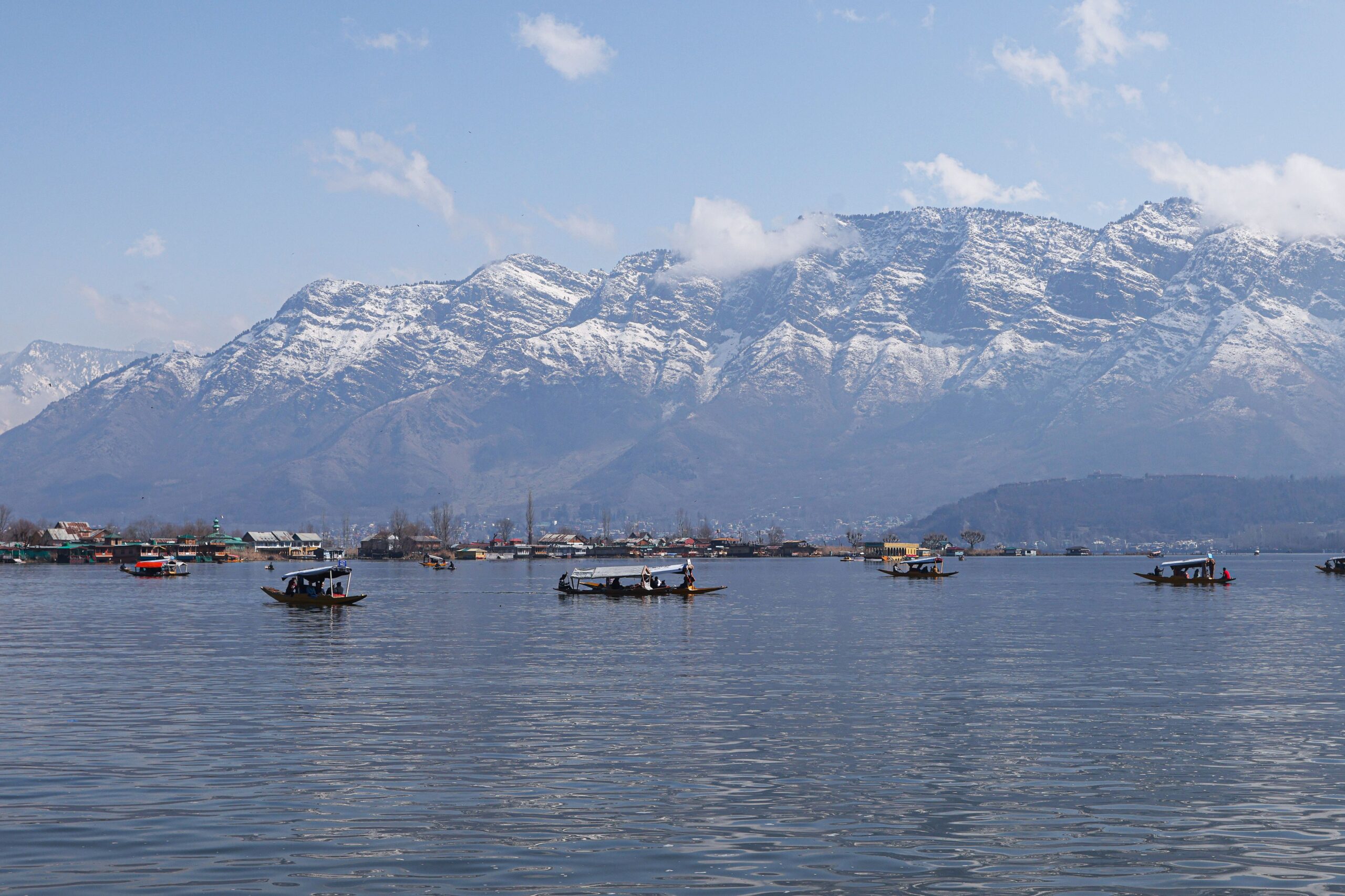 Shikaras on Dal Lake with the majestic Himalayas in the background.